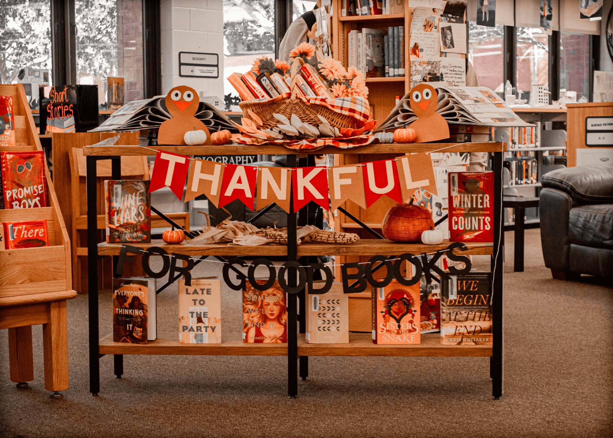 A bookstand in the library with the words Thankful for Good Books