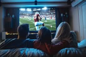 A family watching football on the TV